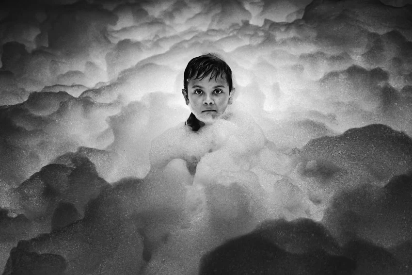 Boy surrounded by foam