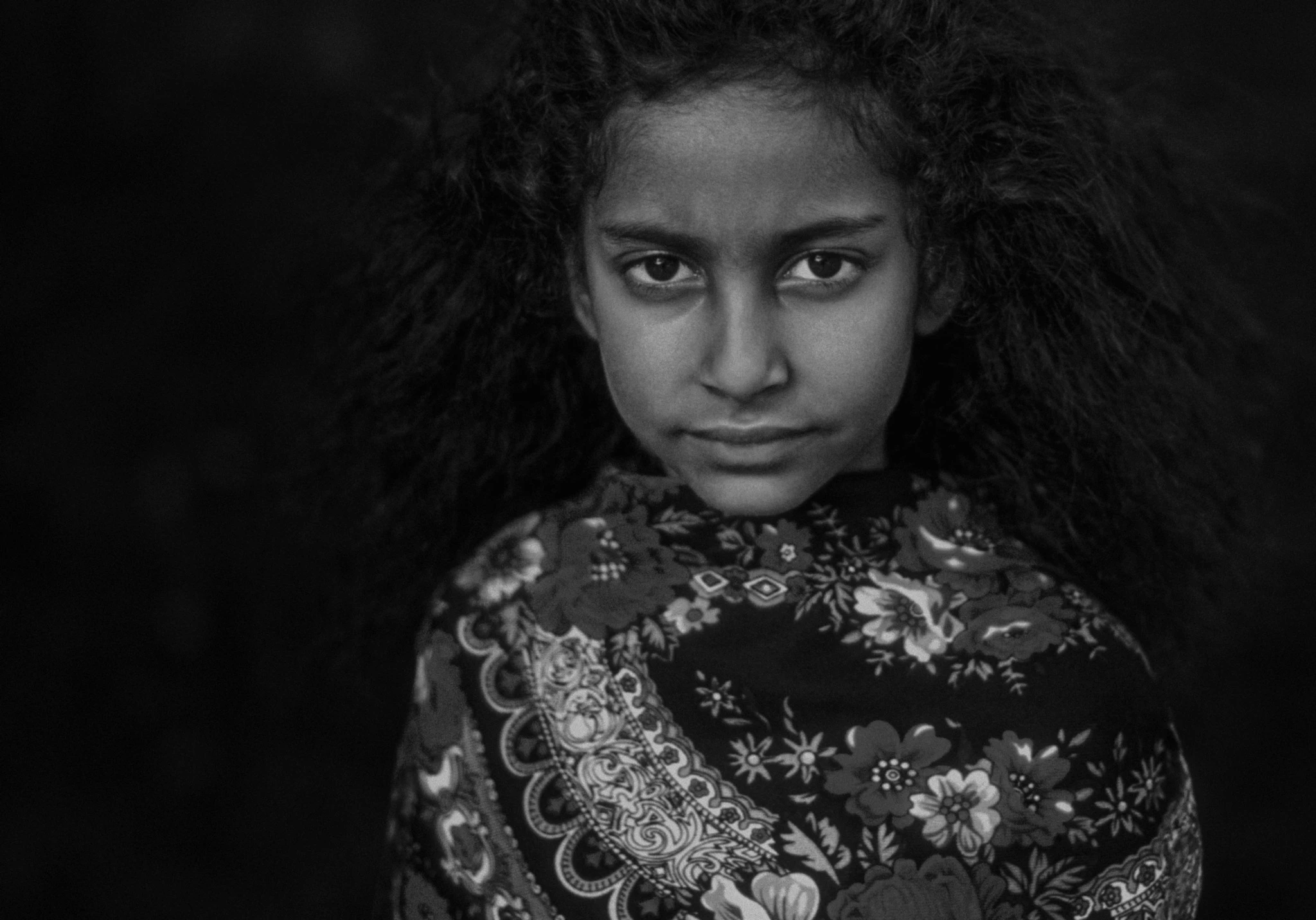 Black and white portrait of a girl wearing a patterned scarf
